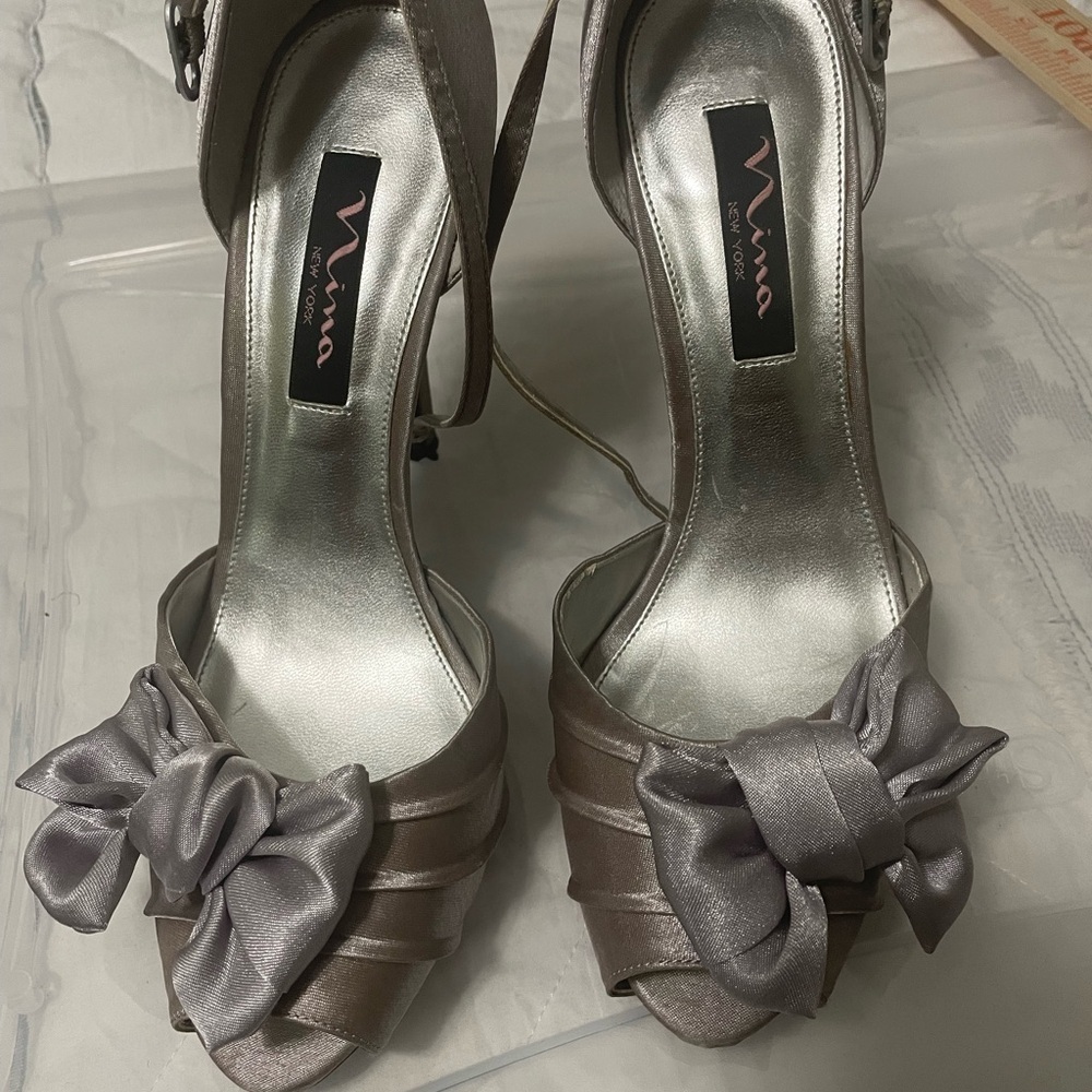 Nina New York silver with lavender hue satin ankle strap‎ heels. Bows